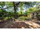 Backyard featuring a birdbath, seating, mature trees and lush landscaping at 2320 Wofford Rd, Charleston, SC 29414