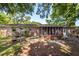 Backyard of a brick home featuring a screened in porch and concrete picnic table at 2320 Wofford Rd, Charleston, SC 29414