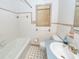 A classic bathroom is complete with a tub, toilet, and a sink with a blue countertop at 2320 Wofford Rd, Charleston, SC 29414