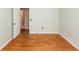 A sunlit bedroom features hardwood floors, a door to another room and an outlet at 2320 Wofford Rd, Charleston, SC 29414
