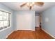 A cozy bedroom with light blue walls and a closet features bright hardwood floors at 2320 Wofford Rd, Charleston, SC 29414
