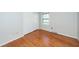 A bright bedroom with hardwood floors and a closet features a window with natural light at 2320 Wofford Rd, Charleston, SC 29414