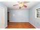 A bright bedroom with hardwood floors and a ceiling fan has light blue painted walls at 2320 Wofford Rd, Charleston, SC 29414