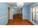 Dining area with blue walls, hardwood floors, and an adjacent door and hallway at 2320 Wofford Rd, Charleston, SC 29414