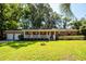 Charming brick home with a white picket fence and a well-manicured green lawn at 2320 Wofford Rd, Charleston, SC 29414
