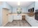 Well-lit kitchen boasts ample counter space, white cabinetry, and modern appliances at 2320 Wofford Rd, Charleston, SC 29414