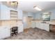 Kitchen with white cabinets, gray flooring, and a built-in desk area at 2320 Wofford Rd, Charleston, SC 29414