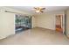 A spacious living room has neutral walls and sliding glass doors to a screened-in patio at 2320 Wofford Rd, Charleston, SC 29414
