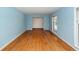 Sunlit living room features light blue walls and warm hardwood flooring at 2320 Wofford Rd, Charleston, SC 29414
