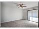Light-filled bedroom with a ceiling fan, neutral carpeting, and sliding glass doors at 2334 Treescape Dr # 2006, Charleston, SC 29414