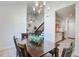Open-concept dining area with a chandelier, table, and view into the living room and staircase, all with ample lighting at 2334 Treescape Dr # 2006, Charleston, SC 29414