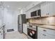 Updated kitchen featuring white cabinetry, stainless steel appliances, granite countertops, and stone backsplash, for cooking at 2334 Treescape Dr # 2006, Charleston, SC 29414