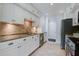 A well-organized kitchen with white cabinets, modern appliances, tile backsplash and flooring, with ample lighting at 2334 Treescape Dr # 2006, Charleston, SC 29414