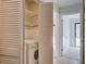Convenient in-unit laundry closet with washer, dryer, and wire shelving at 2334 Treescape Dr # 2006, Charleston, SC 29414