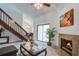 Stylish living room featuring a fireplace, staircase, and dining area, illuminated by natural light and elegant chandelier at 2334 Treescape Dr # 2006, Charleston, SC 29414