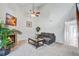 A well-lit living room with a fireplace, comfortable sectional sofa, ceiling fan, and stylish interior design with decorations at 2334 Treescape Dr # 2006, Charleston, SC 29414