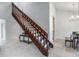 Open staircase with wood railing and a view of the dining area at 2334 Treescape Dr # 2006, Charleston, SC 29414