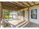 Inviting covered front porch with wooden decking and a cozy seating area at 250 W Medina St, Summerville, SC 29483