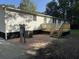 A newly constructed back deck offers a relaxing view of the yard at 260 Lake Dr, Summerville, SC 29483