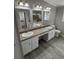 Bathroom features a double sink vanity, new fixtures, and gray wood-look flooring at 260 Lake Dr, Summerville, SC 29483