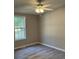Neutral bedroom with ceiling fan, wood-look floors, and a window to let in natural light at 260 Lake Dr, Summerville, SC 29483