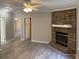 Open-concept living room features a stone fireplace, ceiling fan, and wood-look floors at 260 Lake Dr, Summerville, SC 29483