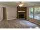 Living room with fireplace, wood-look flooring, natural light, and neutral paint at 260 Lake Dr, Summerville, SC 29483