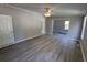 Spacious living room with wood-look floors, ceiling fan, and neutral walls at 260 Lake Dr, Summerville, SC 29483
