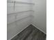 Ample shelving in the walk-in pantry featuring wood-look flooring and neutral walls at 260 Lake Dr, Summerville, SC 29483