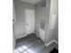 Utility room with white door, gray walls and wood-look flooring at 260 Lake Dr, Summerville, SC 29483