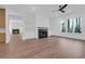 Open concept living room showcases a sleek fireplace, recessed lighting, and beautiful hardwood floors at 2640 Battle Trail Dr, Johns Island, SC 29455