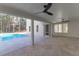 Covered patio with a ceiling fan offering a tranquil outdoor living space with serene views of the pool and backyard at 2640 Battle Trail Dr, Johns Island, SC 29455
