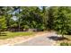 The landscaped street and fenced lot features a paved driveway at 2640 Battle Trail Dr, Johns Island, SC 29455