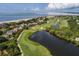 Stunning aerial view of coastal community with golf course, beachfront homes, and ocean views at 2645 Gnarled Pine, Seabrook Island, SC 29455
