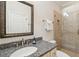 Elegant bathroom featuring granite countertop and tiled shower, exudes spa-like ambiance at 2645 Gnarled Pine, Seabrook Island, SC 29455