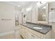 Bright bathroom featuring double vanity with granite countertop and large mirrors at 2645 Gnarled Pine, Seabrook Island, SC 29455