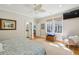 Bedroom featuring ceiling fan, hardwood floors, and ensuite bath at 2645 Gnarled Pine, Seabrook Island, SC 29455