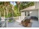 Private deck with seating and a grill, surrounded by lush greenery and mature trees for serene outdoor living at 2645 Gnarled Pine, Seabrook Island, SC 29455