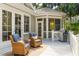 Relaxing deck with wicker chairs, a small table, and a grill, perfect for outdoor entertainment at 2645 Gnarled Pine, Seabrook Island, SC 29455