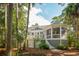 The home's exterior features a screened in porch, deck, and manicured landscaping at 2645 Gnarled Pine, Seabrook Island, SC 29455