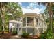 The home's exterior features a screened in porch, deck, and lush landscaping at 2645 Gnarled Pine, Seabrook Island, SC 29455