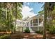 The home's exterior features a screened in porch, deck, and manicured landscaping at 2645 Gnarled Pine, Seabrook Island, SC 29455