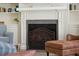 Close-up shot of the decorative fireplace with granite surround, built-in shelving, and an iron screen at 2645 Gnarled Pine, Seabrook Island, SC 29455