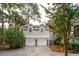 View of the home's two-car garage, with the lovely crape myrtle tree and beautiful landscaping at 2645 Gnarled Pine, Seabrook Island, SC 29455