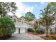 View of the home's exterior with the two car garage, steps to the front door and landscaped yard at 2645 Gnarled Pine, Seabrook Island, SC 29455