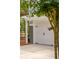 Two-car garage featuring white doors and black hardware, framed by a pergola and crape myrtle at 2645 Gnarled Pine, Seabrook Island, SC 29455