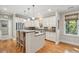 Bright kitchen boasts stainless steel appliances, granite countertops, kitchen island and hardwood floors at 2645 Gnarled Pine, Seabrook Island, SC 29455