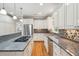 Bright kitchen with stainless steel appliances, granite countertops, island cooktop, and hardwood floors at 2645 Gnarled Pine, Seabrook Island, SC 29455