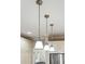 Modern pendant lighting above the island in the kitchen illuminates the cooking space and adds style at 2645 Gnarled Pine, Seabrook Island, SC 29455