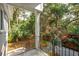 Covered porch showcasing outdoor views, black metal railings, and landscaped garden at 2645 Gnarled Pine, Seabrook Island, SC 29455